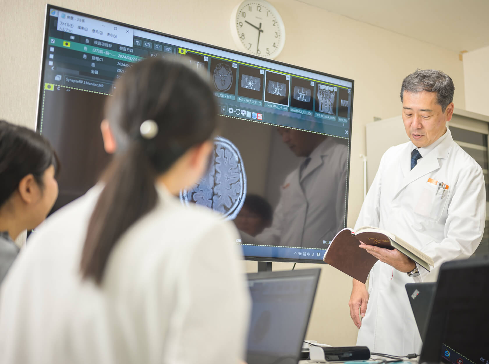 写真:脳のMRI画像を見ながら指導している様子